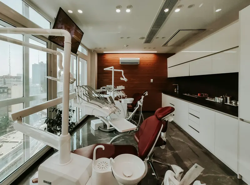 A bright dental treatment room with a patient chair